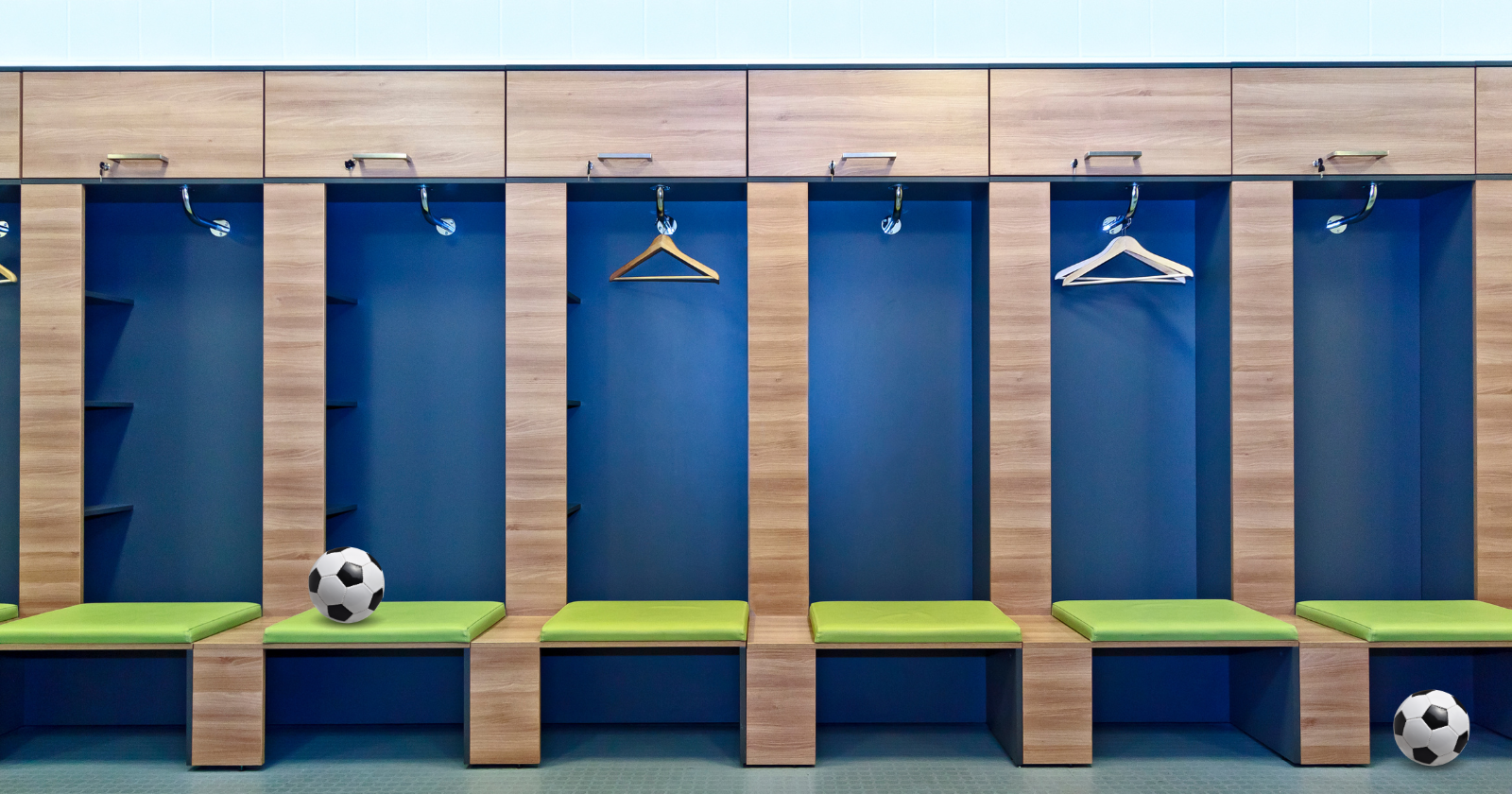 Empty locker room with 2 soccer balls.